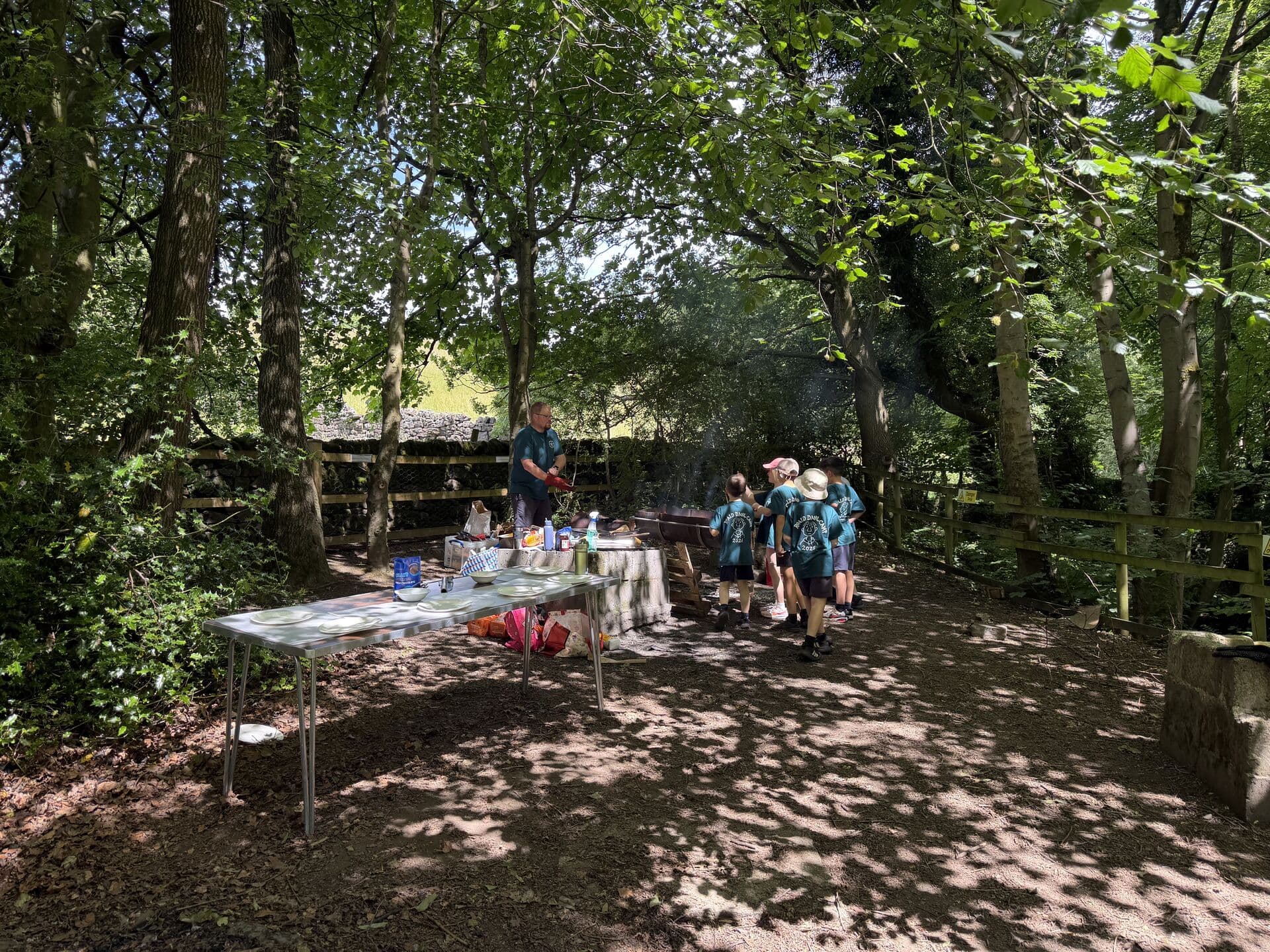 Beavers gathering around a barbecue in the woods