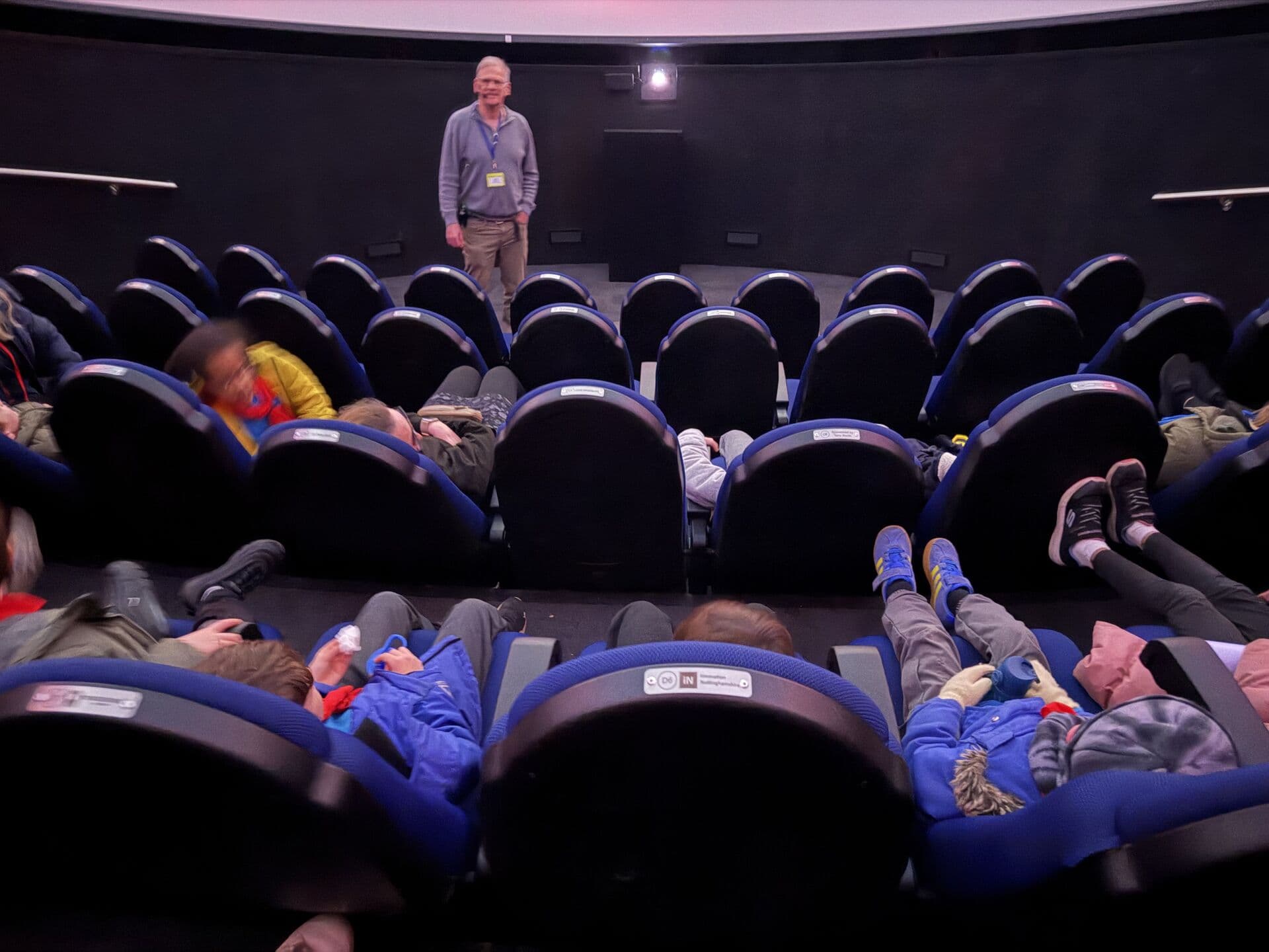 Beavers watching a presentation at a planetarium