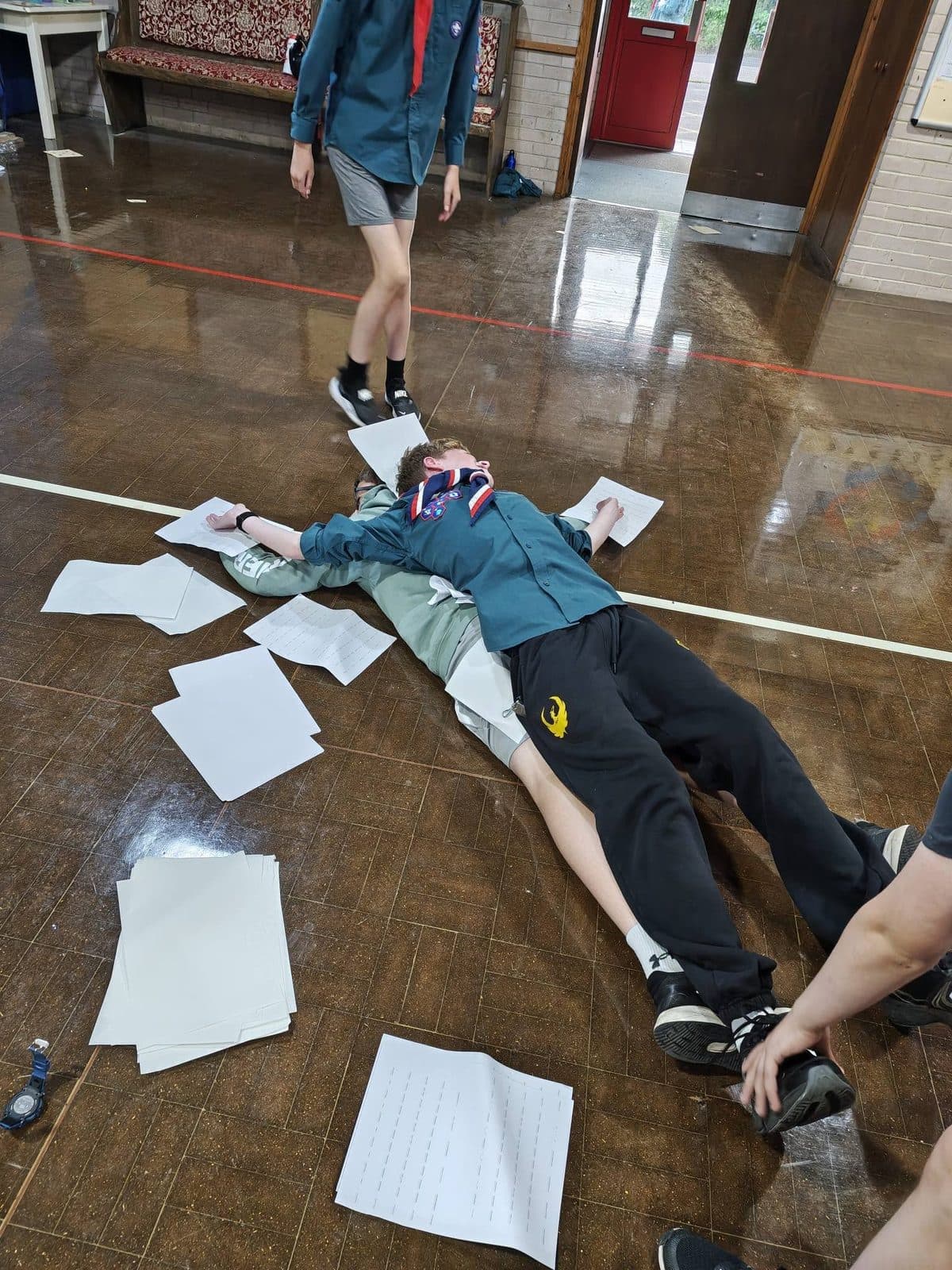 A Scout practising first aid casualty care on a teammate