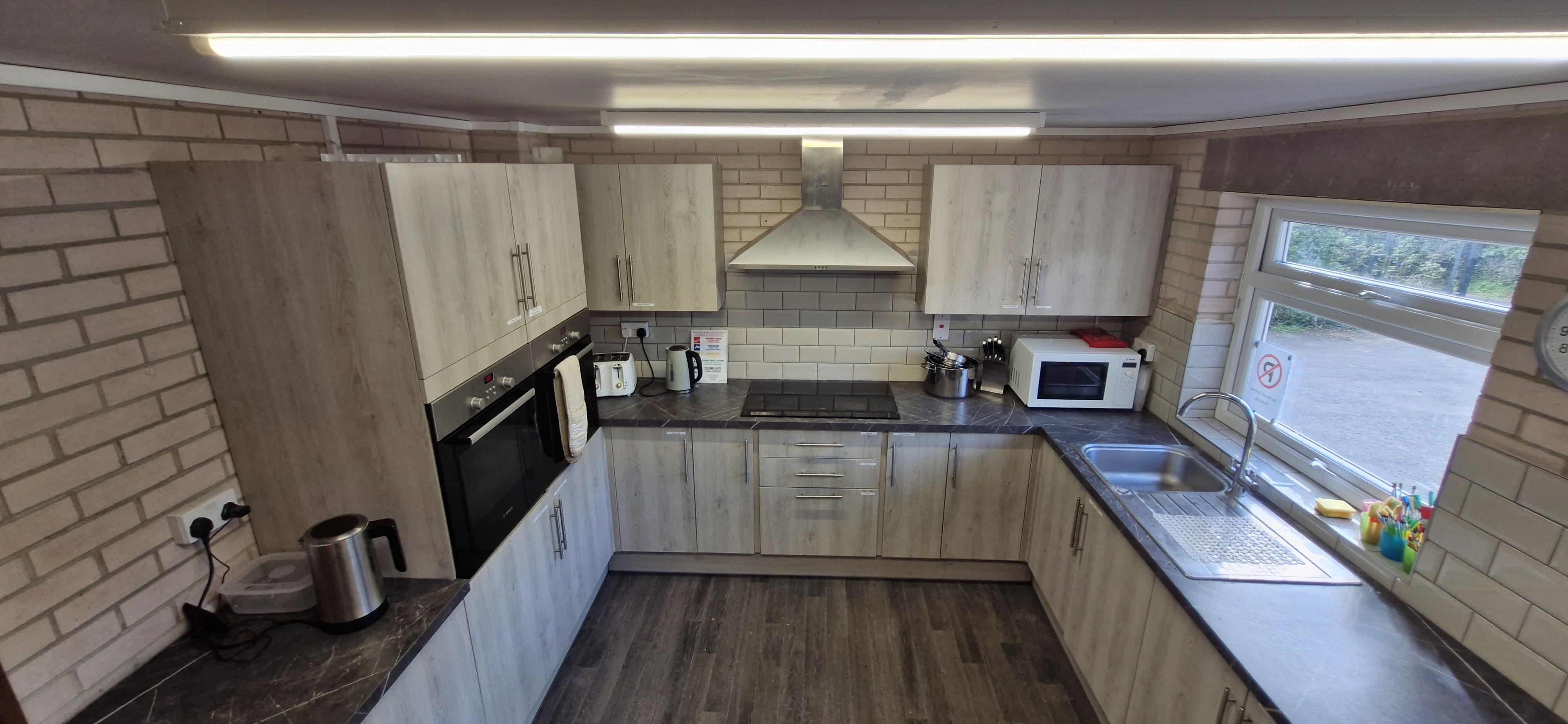 Fully fitted kitchen with oven, microwave, kettle and sink
